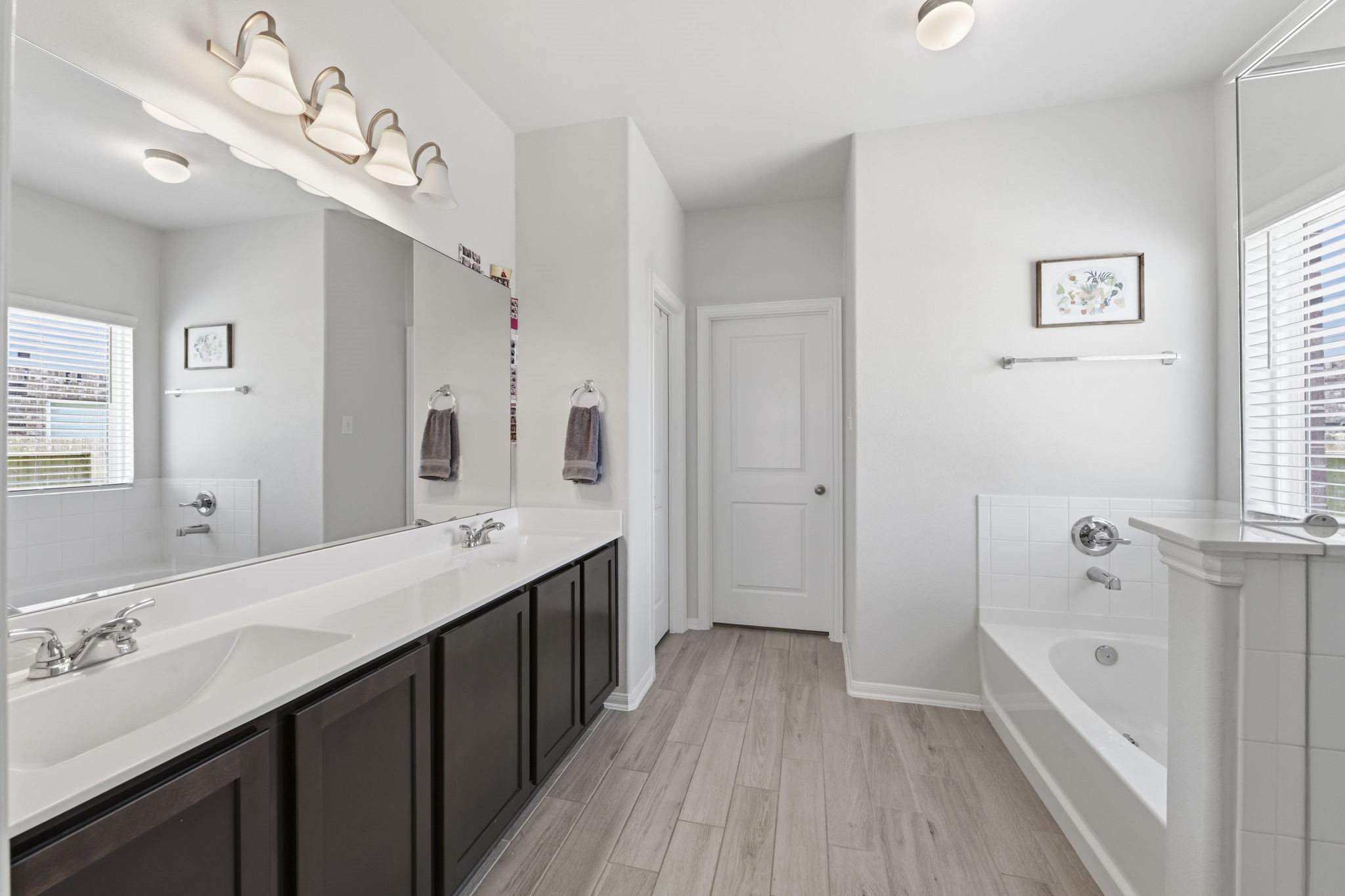 2401 Abbot Brk Drive Rosharon, TX 77583 - Photo 20 of 50 The dual vanities feature elegant solid-surface countertops with integrated rectangular sinks, complemented by additional counter space between them to provide exceptional functionality for busy mornings. Thoughtfully designed with both comfort and style in mind, this en-suite bath serves as a true soothing sanctuary within the home.