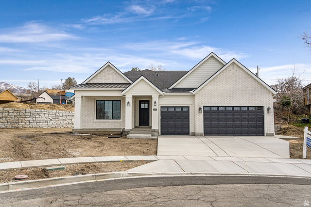 296 East 2050 South, Unit 2 Bountiful, UT 84010 - Photo 1 of 1 Modern farmhouse style home featuring a garage, concrete driveway, brick siding, and a standing seam roof