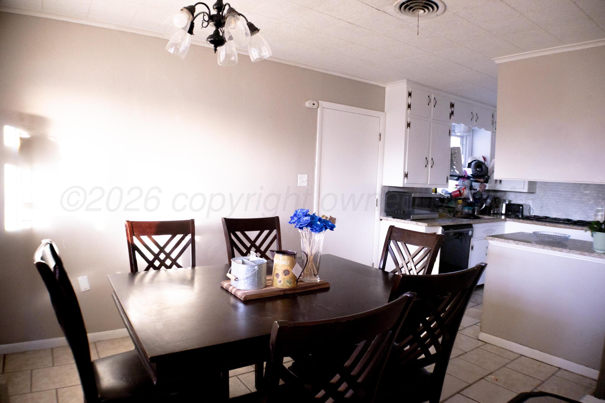 4711 South Rusk Street Amarillo, TX 79110 - Photo 8 of 24 a view of a dining room with furniture and wooden floor