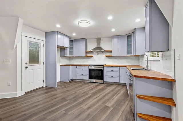 a kitchen with kitchen island a sink stainless steel appliances and cabinets