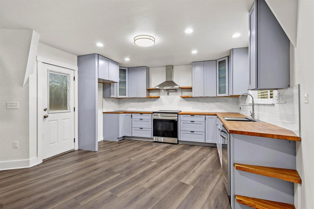 1325 Reynolds Road Whitewright, TX 75491 - Photo 11 of 39 a kitchen with kitchen island a sink stainless steel appliances and cabinets
