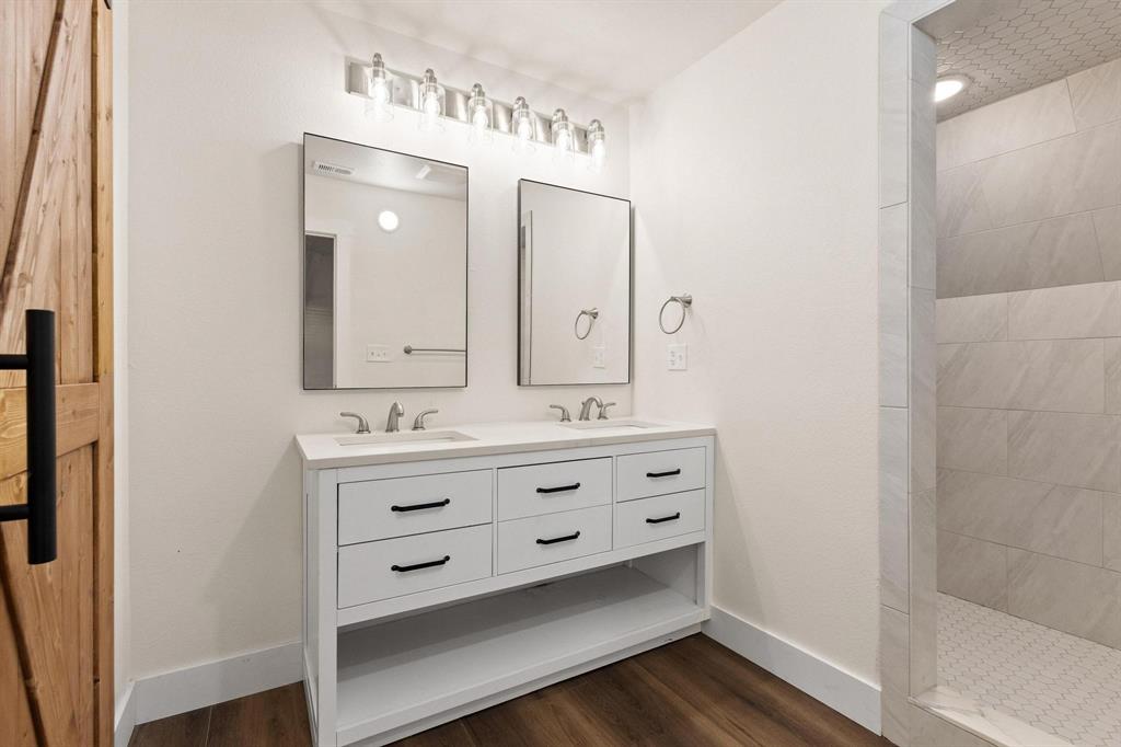 1325 Reynolds Road Whitewright, TX 75491 - Photo 13 of 39 a bathroom with a granite countertop sink mirror and double