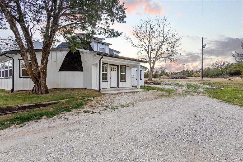 1325 Reynolds Road Whitewright, TX 75491 - Photo 2 of 39 a view of a house with a yard and large trees