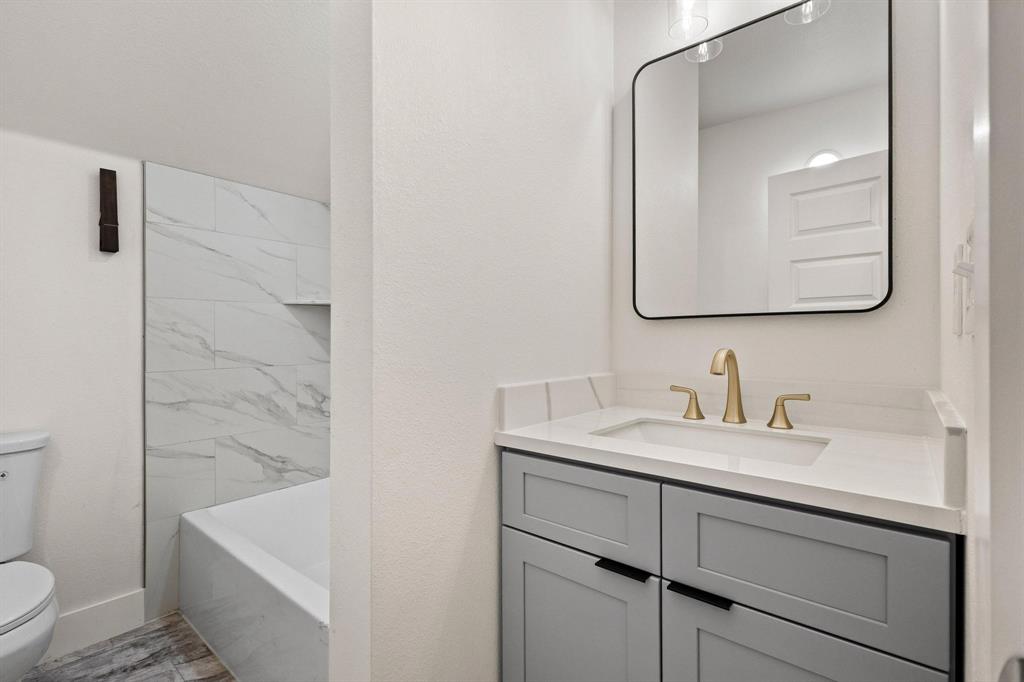 1325 Reynolds Road Whitewright, TX 75491 - Photo 24 of 39 a bathroom with a sink a toilet and shower