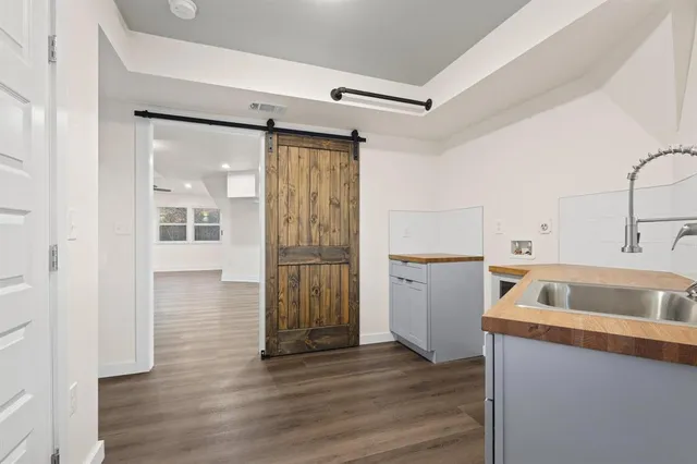 a kitchen with a refrigerator sink and cabinets