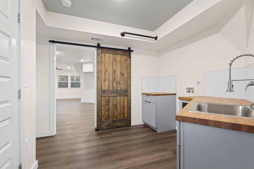 1325 Reynolds Road Whitewright, TX 75491 - Photo 26 of 39 a kitchen with a refrigerator sink and cabinets