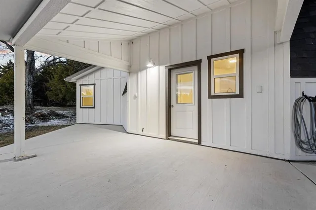 a view of an empty room with a fireplace and a window