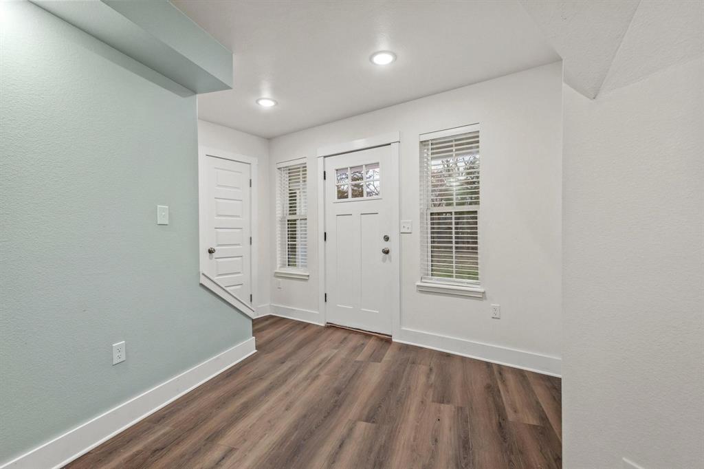 1325 Reynolds Road Whitewright, TX 75491 - Photo 8 of 39 an empty room with wooden floor and windows