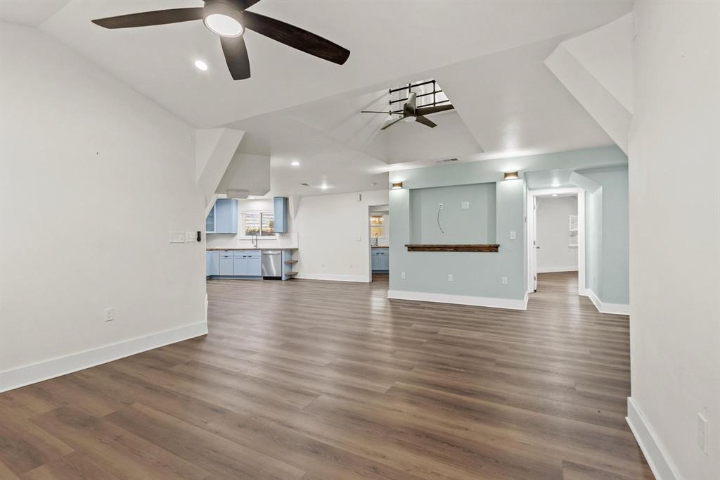 1325 Reynolds Road Whitewright, TX 75491 - Photo 10 of 39 an empty room with wooden floor and windows