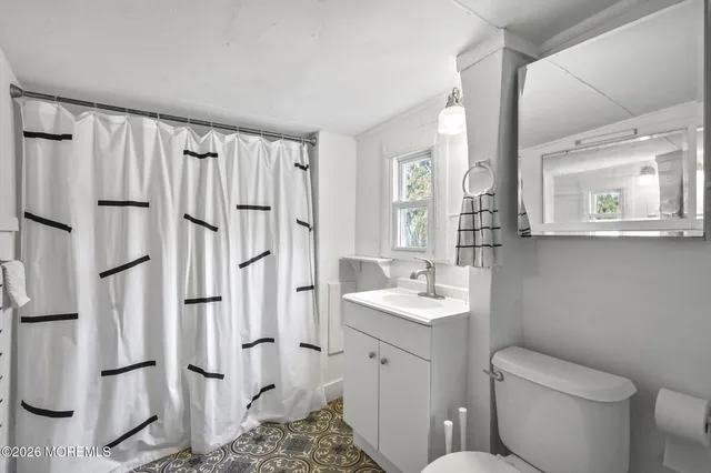 a bathroom with a toilet sink and a mirror