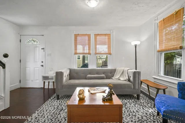 a living room with furniture a rug and a window