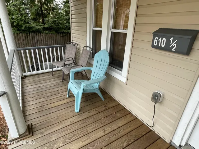 a view of a wooden chairs on the deck
