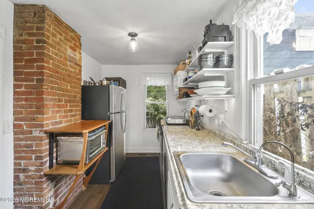 a kitchen with a refrigerator and a sink