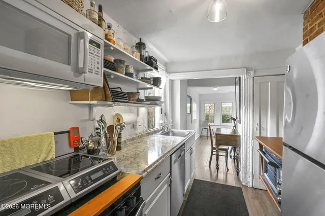 a kitchen with a stove and a refrigerator