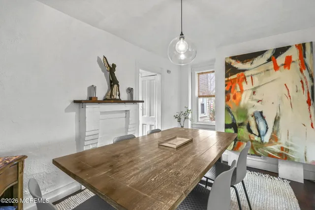 a view of a dining room with furniture and a chandelier