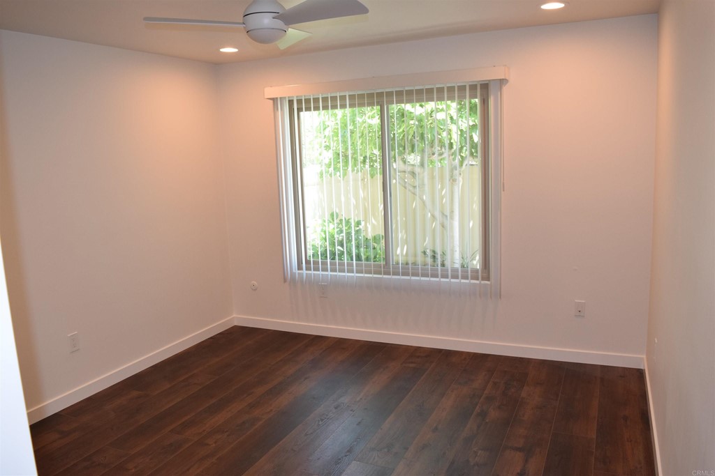 1723 Kellington Place Encinitas, CA 92024 - Photo 11 of 23 an empty room with wooden floor and windows