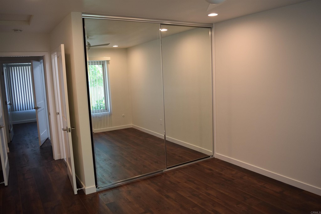 1723 Kellington Place Encinitas, CA 92024 - Photo 12 of 23 an empty room with wooden floor and door