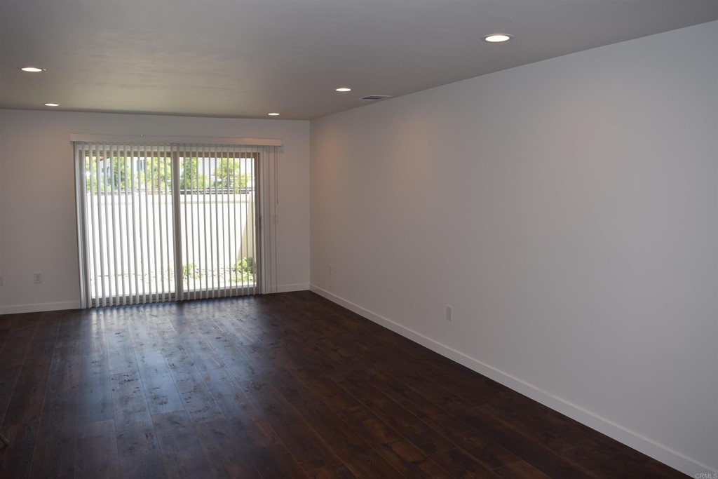 1723 Kellington Place Encinitas, CA 92024 - Photo 5 of 23 a view of an empty room with wooden floor and a window