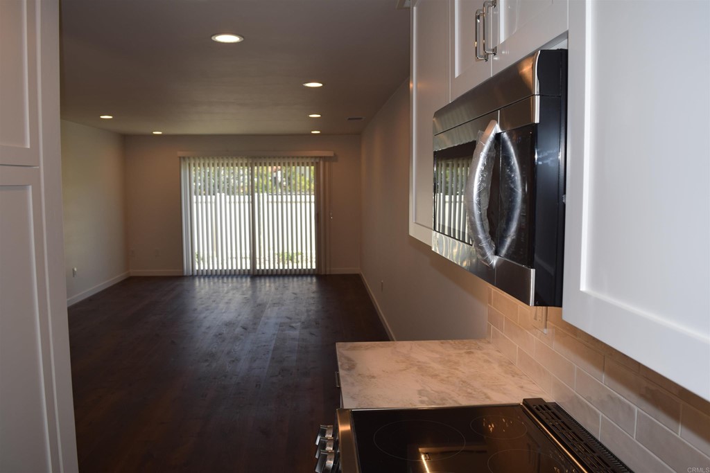1723 Kellington Place Encinitas, CA 92024 - Photo 10 of 23 a view of a hallway with wooden floor and staircase