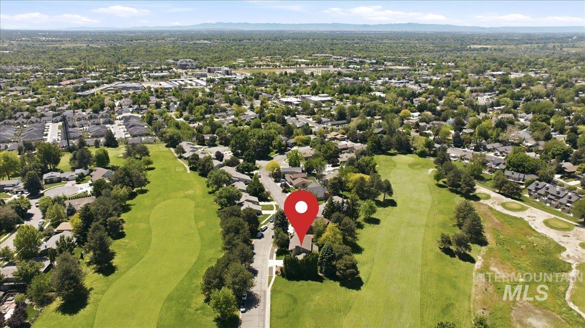 599 Pebble Beach Way Eagle, ID 83616 - Photo 40 of 44 Aerial perspective showcasing a property situated alongside a golf course, surrounded by residential areas and extensive tree coverage