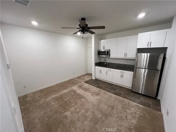 a kitchen with stainless steel appliances a refrigerator and a stove top oven