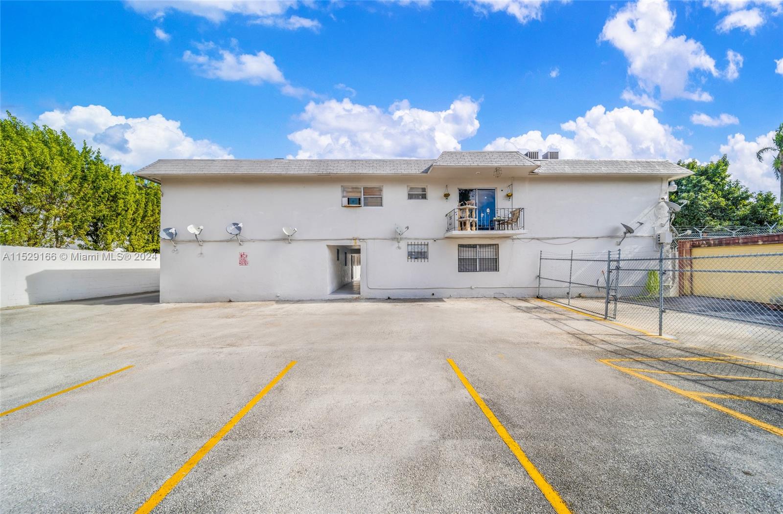 13240 Port Said Road Opa-Locka, FL 33054 - Photo 11 of 21 a front view of a house with a yard and garage