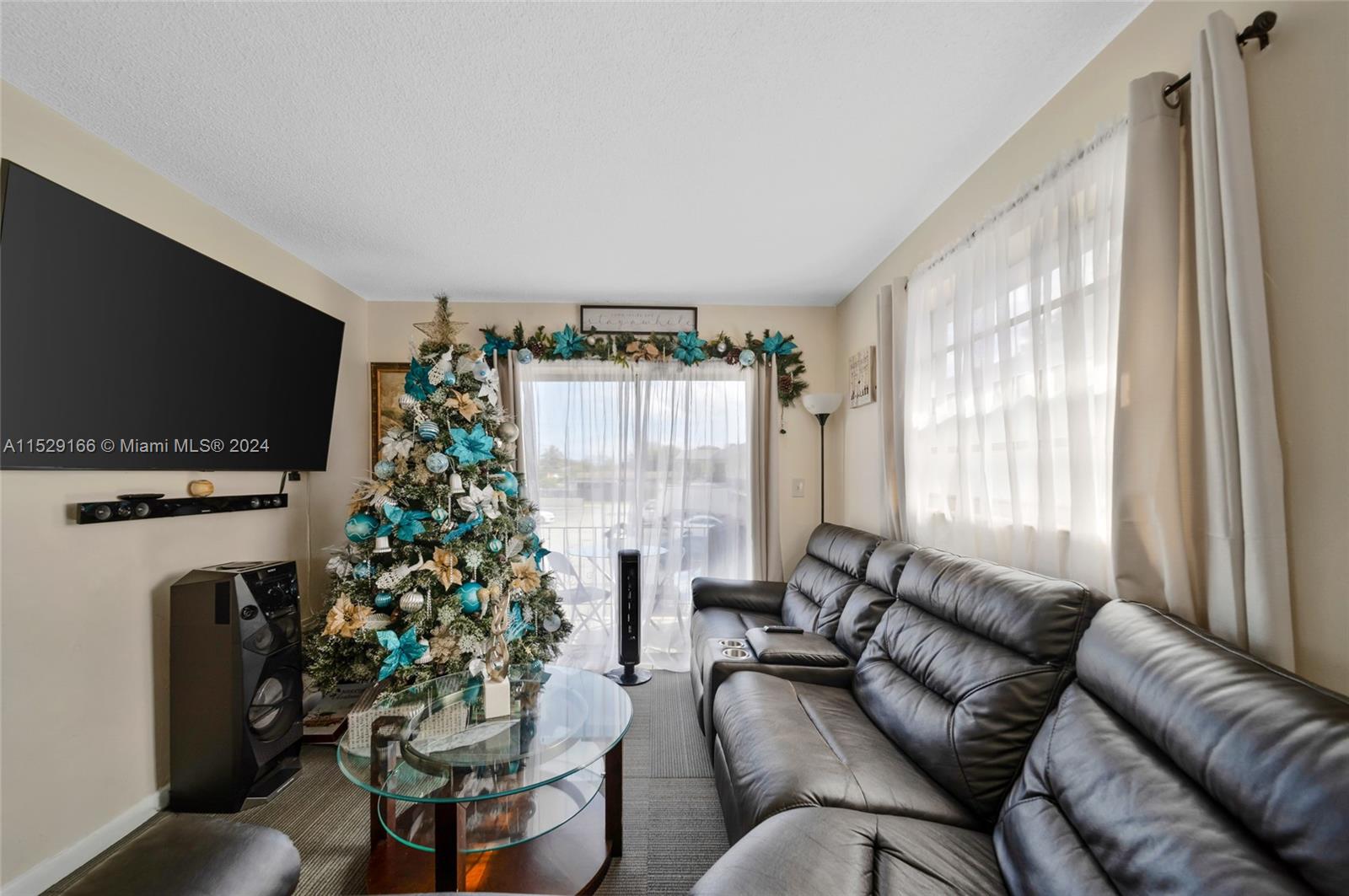13240 Port Said Road Opa-Locka, FL 33054 - Photo 12 of 21 a living room with furniture a flat screen tv and a large window