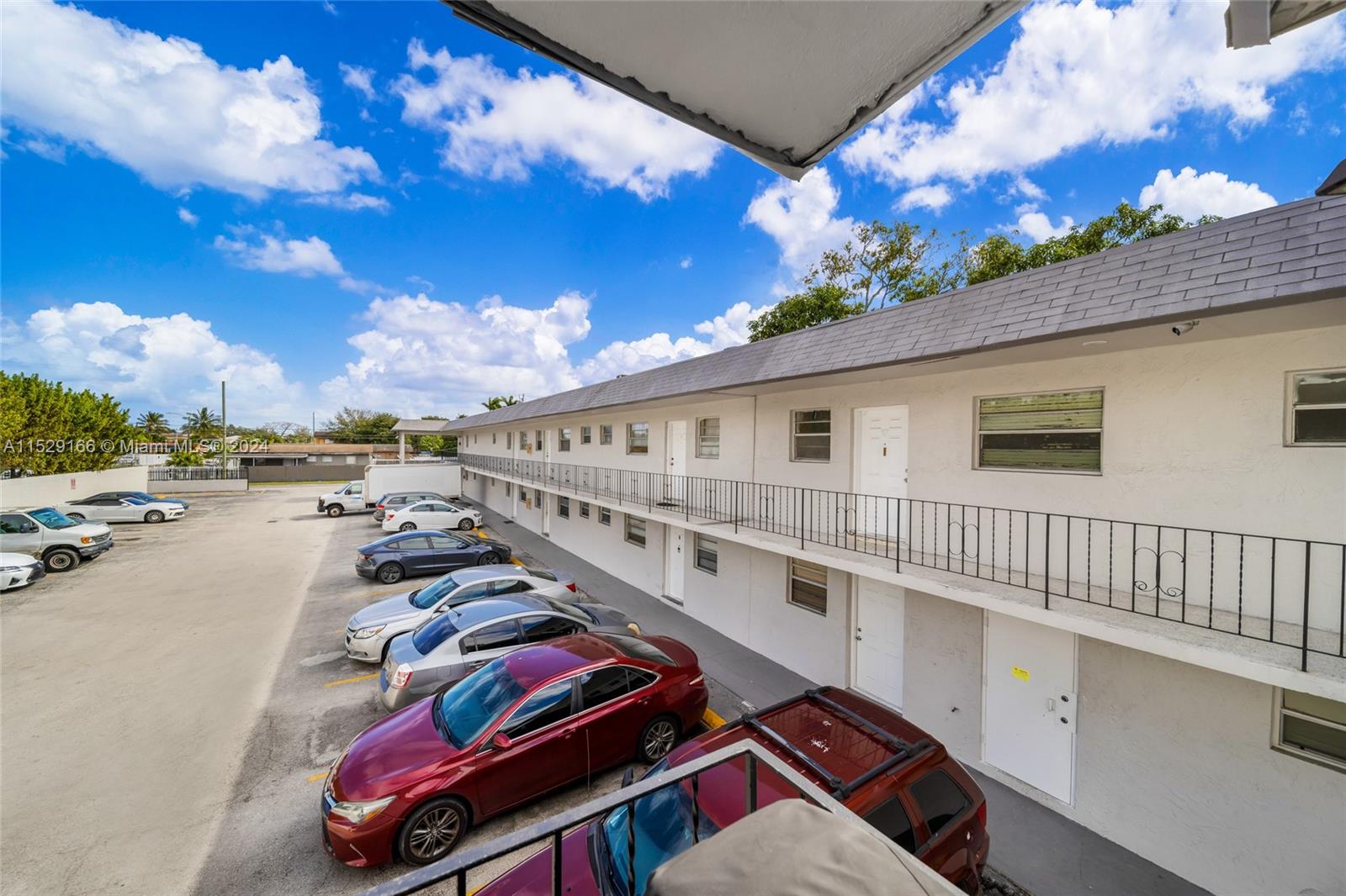 13240 Port Said Road Opa-Locka, FL 33054 - Photo 13 of 21 a balcony with hardwood wall table and chairs