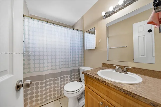 a kitchen with stainless steel appliances granite countertop a refrigerator sink stove and white cabinets