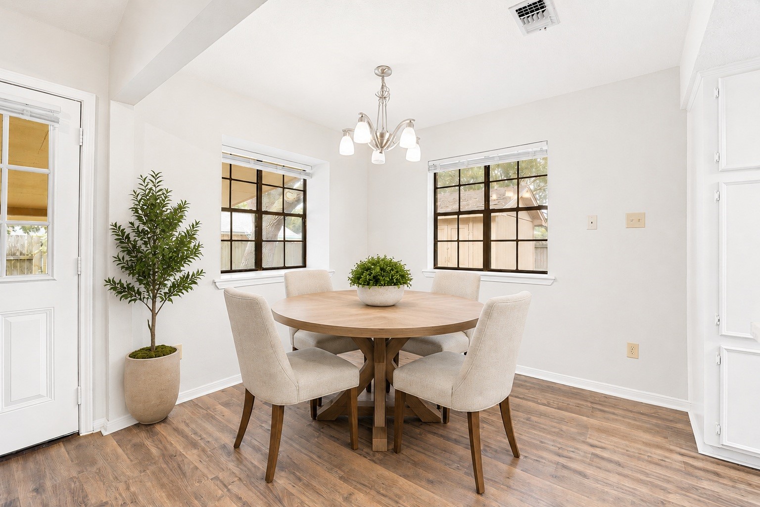 2019 Franklin Circle Rosenberg, TX 77471 - Photo 8 of 19 The breakfast room sits just off the kitchen beneath a chandelier, with two windows framing backyard views and a door opening directly to the yard and patio. Virtually staged.