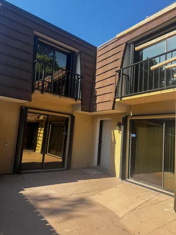 a front view of a house with large windows