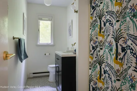 a bathroom with a toilet and a shower curtain