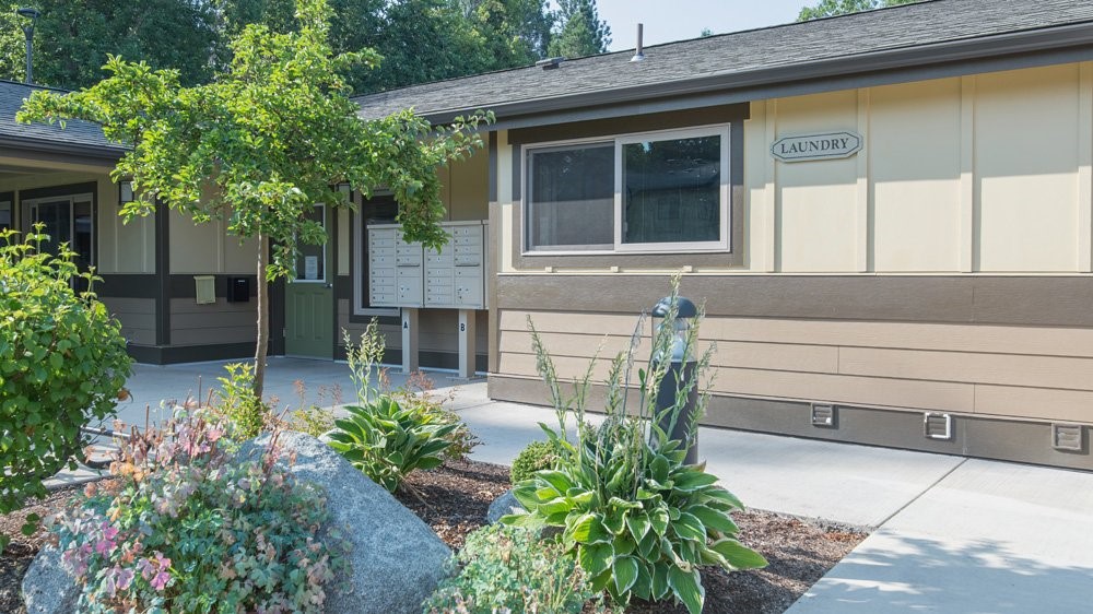 1108 South Rose Street, Unit 50 Phoenix, OR 97535 - Photo 1 of 10 a front view of a house with a garden