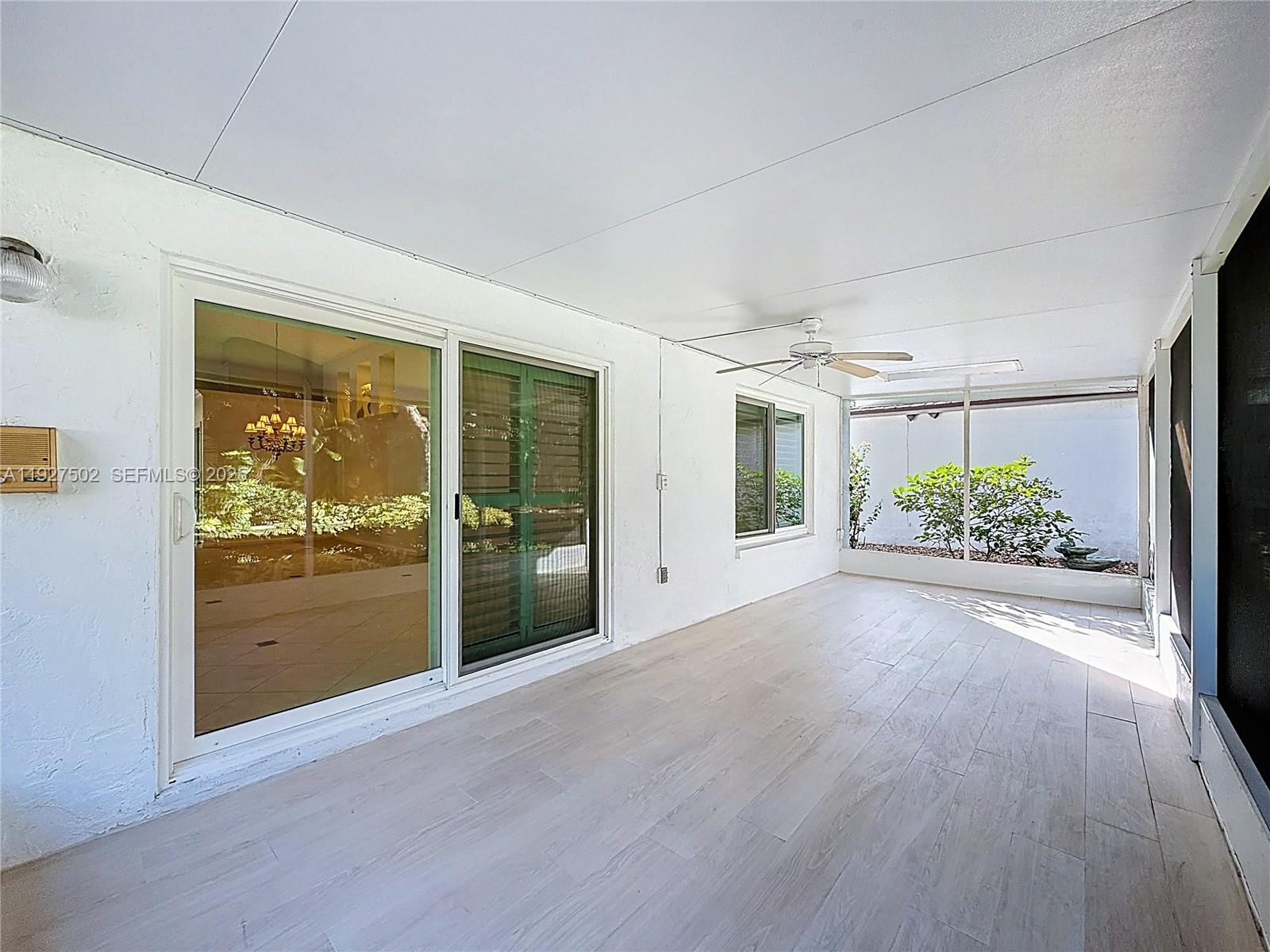356 Hammocks Trail Greenacres, FL 33413 - Photo 15 of 41 wooden floor in an empty room with a window