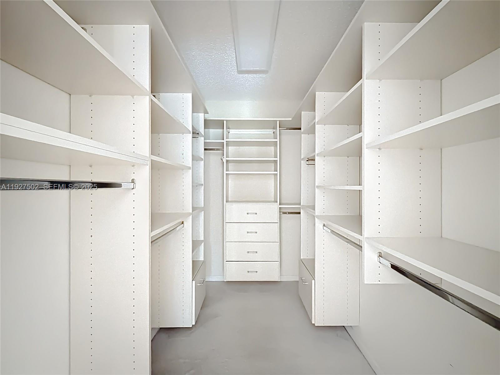 356 Hammocks Trail Greenacres, FL 33413 - Photo 17 of 41 a view of walk in closet with empty racks