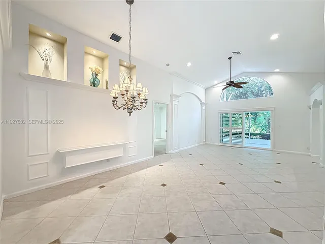 a view of kitchen with window and chandelier