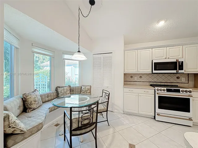a kitchen with stainless steel appliances granite countertop a sink refrigerator and cabinets