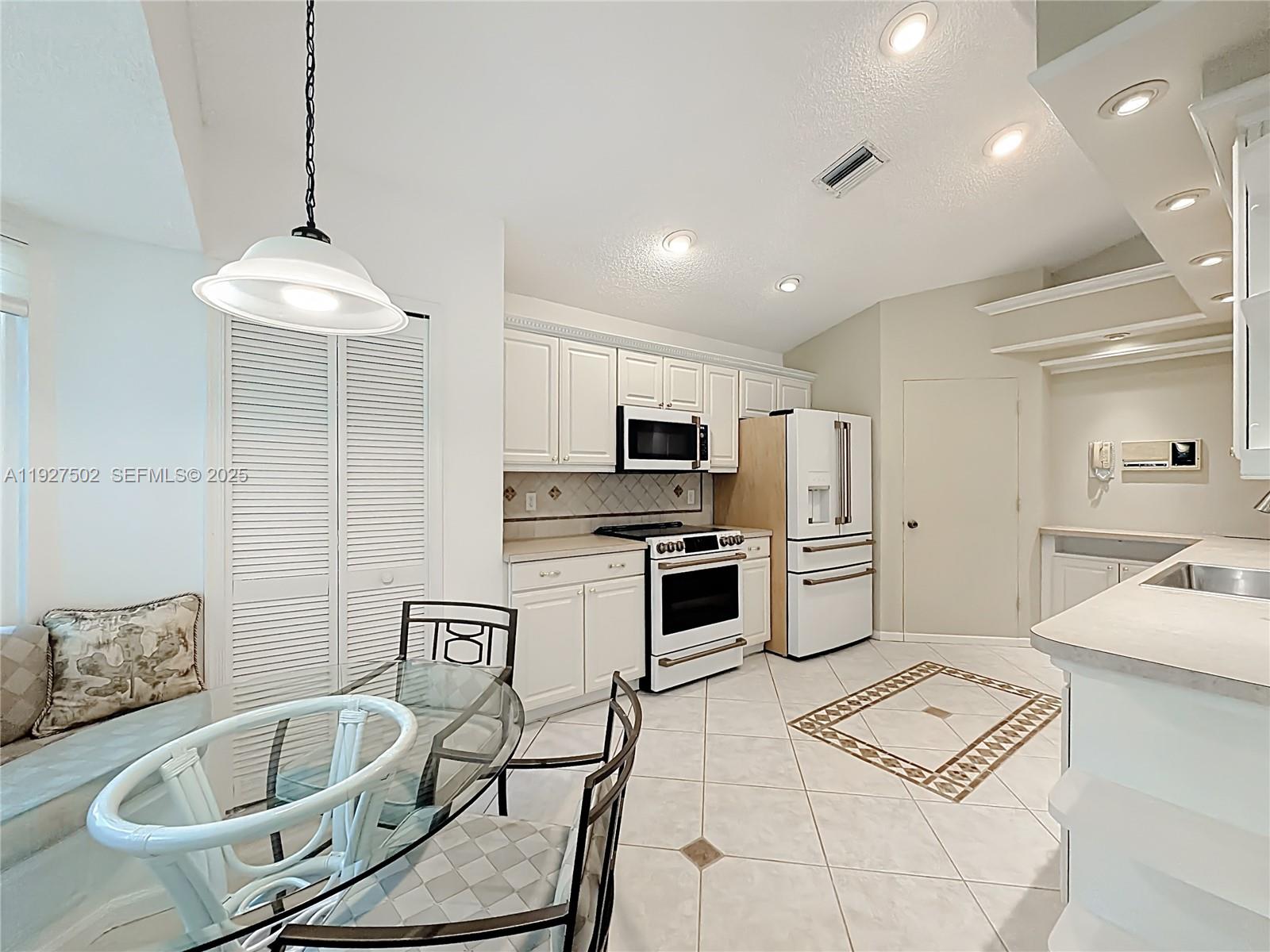 356 Hammocks Trail Greenacres, FL 33413 - Photo 8 of 41 a kitchen with stainless steel appliances granite countertop a sink refrigerator and cabinets