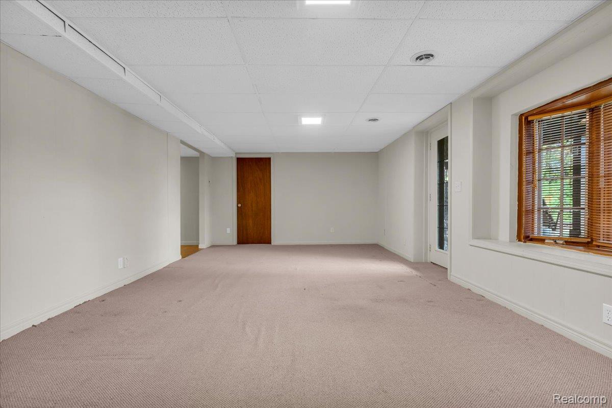 1156 Seneca Road Lake Orion, MI 48362 - Photo 23 of 50 Carpeted empty room featuring a drop ceiling and baseboards