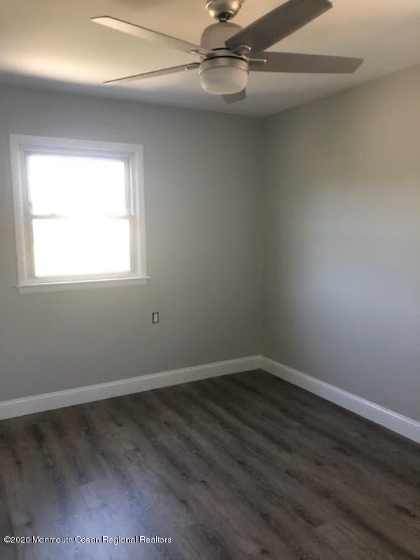 2 Higgins Court Brick, NJ 08724 - Photo 12 of 21 an empty room with wooden floor fan and windows