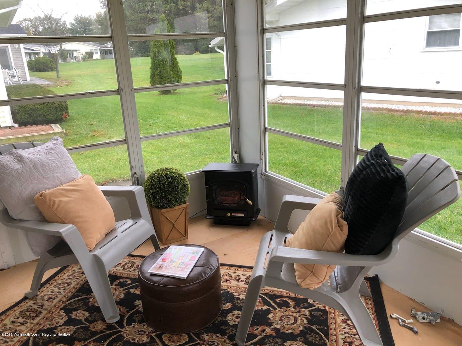 2 Higgins Court Brick, NJ 08724 - Photo 7 of 21 a living room with furniture and a floor to ceiling window