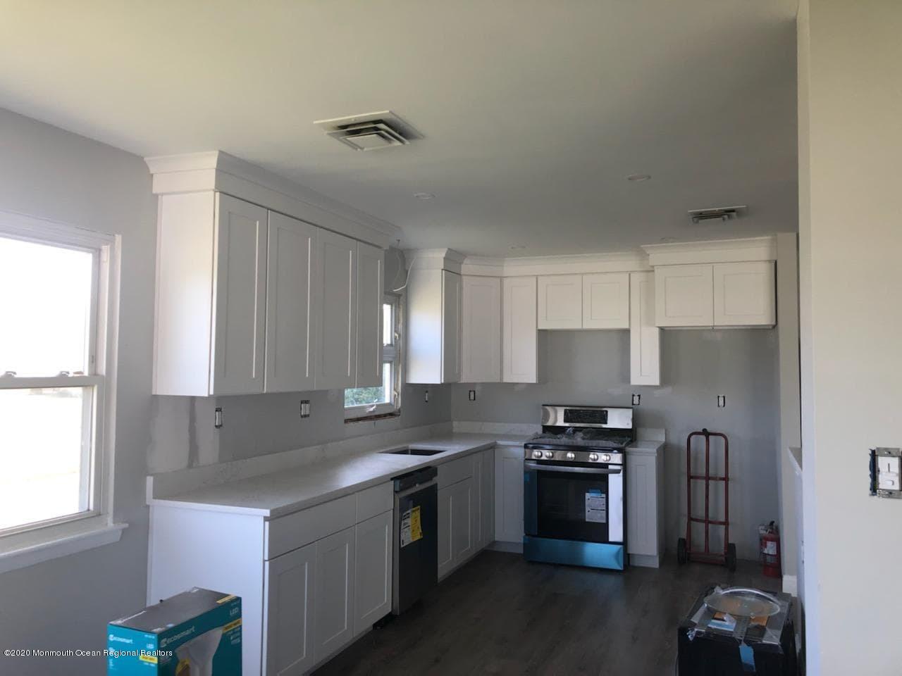 2 Higgins Court Brick, NJ 08724 - Photo 10 of 21 a kitchen with stainless steel appliances a sink a stove a microwave a refrigerator and cabinets