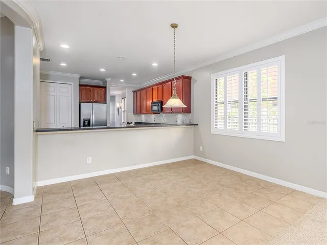 an empty room with windows and ceiling fan