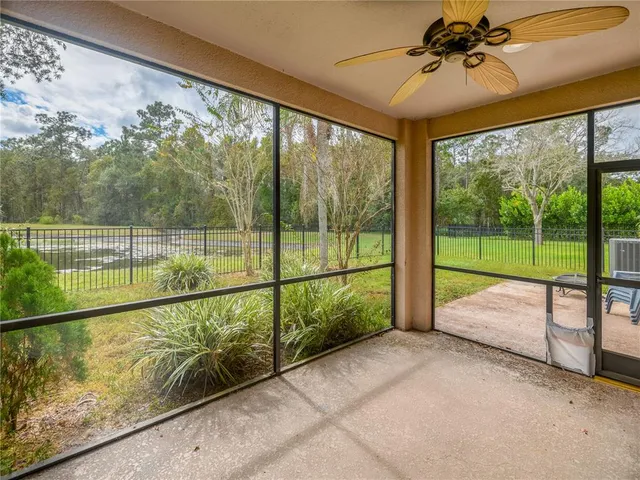 a bathroom with a granite countertop sink a mirror a bathtub and next to a window