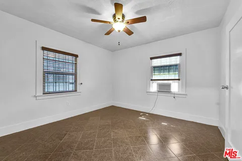 a room with a baby crib dresser and a window