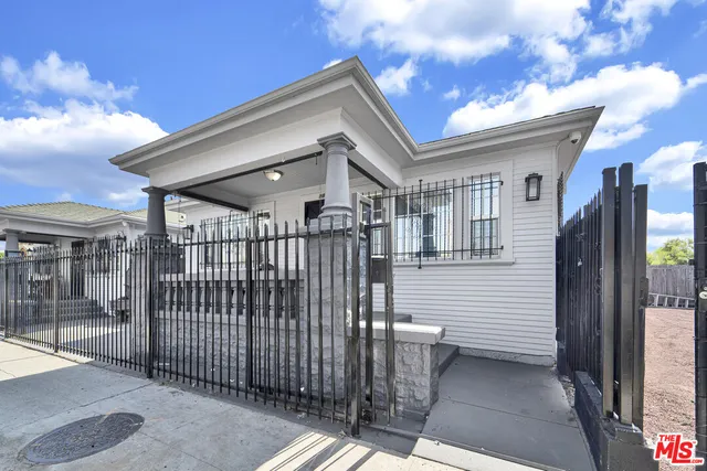 a view of a house with wooden fence