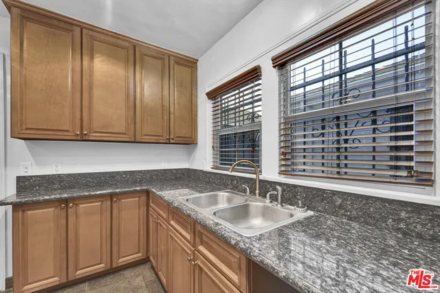 a kitchen with a refrigerator stove and cabinets
