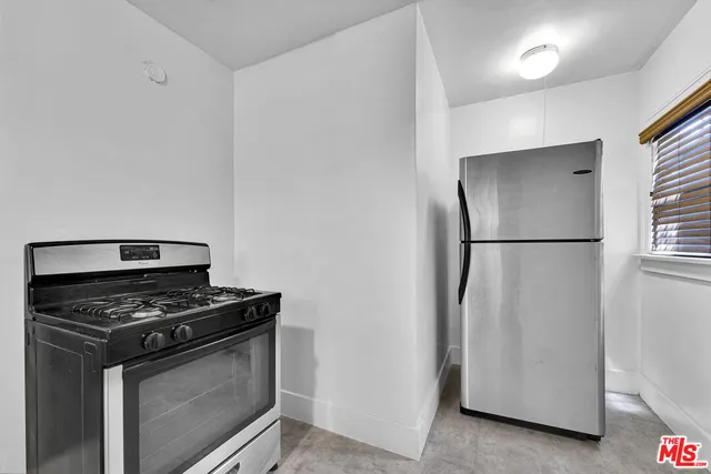 a view of a livingroom with a ceiling fan and window