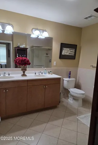 a bathroom with a sink mirror and toilet