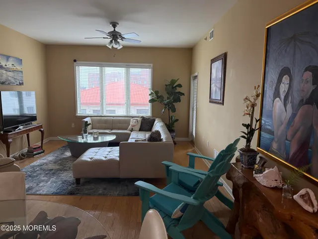 a living room with furniture gym equipment and a window